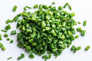 Chopped green onions on a white background, ready for culinary use. photo