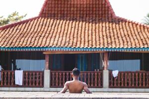 Unidentified man Admiring Scenic Villa View from Behind. Timeless Beauty of a Rustic Traditional Villa. photo