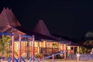 Joglo Guesthouse with Playful Garden in Front. Classic Traditional Home Design. photo