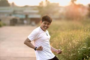 a man who stood and smiled goofily. The man acted like he was running. set in nature on a sunny afternoon. photo