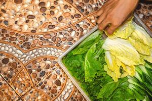Chinese cabbage in a horizontal position in the photo from the right. Chinese cabbage put in a box to be washed. vegetables prepared to make sukiyaki.