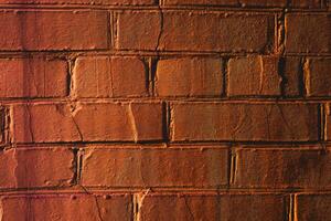 Just orange brick wall for background with shadows photo
