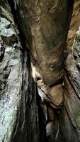Sun rays pass through the stones in a cave. Poland photo