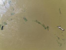 Mudflow of water in the Oder River of brown color. Poland. View from above. Background. photo