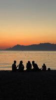 Sunset on the beach, people watching the sunset on the Adriatic Sea in Croatia. Silhouette photography photo