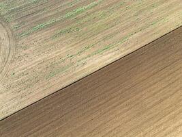 Plowed agricultural field, view from above, background. photo