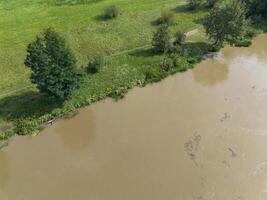 Mudflow of water in the Oder River of brown color. Poland. View from above. Background. photo