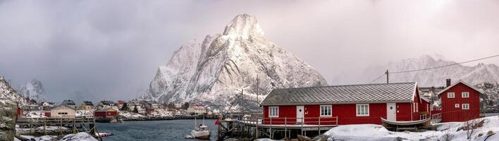 Panorama of Red house snowy with snow mountain on harbor at arctic coastline photo