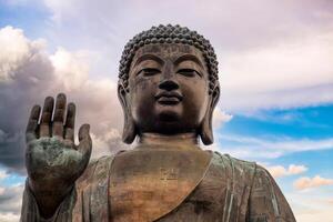 Tian Tan big buddha bronze statue with colorful sky in Hong Kong photo