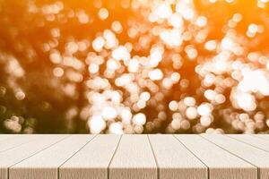 Wooden Table with Light Beam, Shadow, and Bokeh Background photo