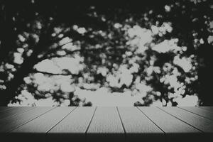 Wooden Table with Blurred Dark Jungle Background with Beautiful Bokeh photo