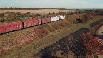 freight train with building materials is passing by rail to the destination. Aerial view video
