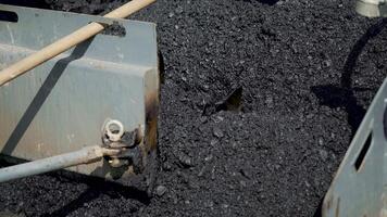 professional equipment with a mixer is blending a mix of rubble, tar, sand and bitumen for stowage asphalt on the highway. Manufacturing technology of asphalt concrete sweep for road works video