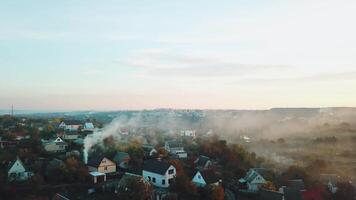 smoke are enveloping the private sector of the city as a result of a fire after a drought. Aerial view video