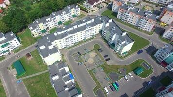 modern buildings with infrastructure in aerial view. Quarter with high-rise buildings is on a green lawn background video