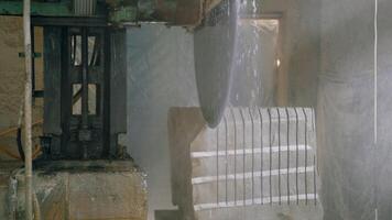 a professional machine is cutting a large stone in the building of a stone processing plant. Stone processing technology using water video