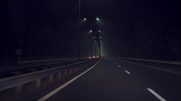 car is driving quickly along the highway in the dark. Night travel by car. Movement speed video
