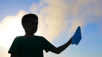 Kid Playing With Paper Airplane. Happy kid playing with paper airplane in the sunset near air pollution video