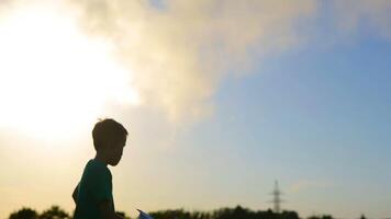 Kid Hand Taking Plane. Kid hand taking playing paper plane in the grass near factory video