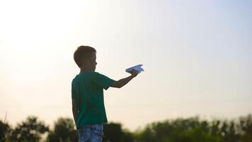 Paper Airplane In Child Hand. Happy little girl Putting a paper airplane near factory video