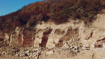 view of a large sand quarry with stones and forest. Professional equipment works for the extraction of sand. Camera motion left video