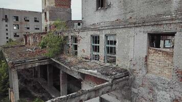 Aerial view of abandoned industrial buildings. Abandoned factory halls with broken glass on windows. video