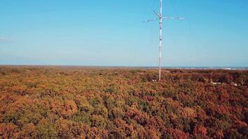 aerial view of the TV tower on the background of the forest. Camera motion up video