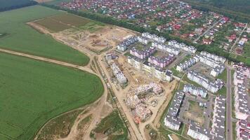 process of building modern high-rise buildings in the new part of the city. View of the buildings on the outskirts of the city. Aerial view. video