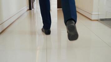 man in business clothes is running through the building to the workplace. Late during working hours video