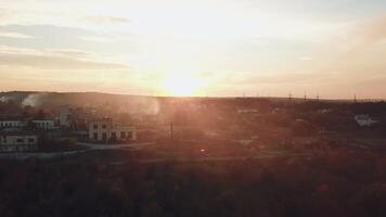 view of the suburban infrastructure which covered with smoke after a fire from a drought at sunset on a warm summer evening. Aerial view video
