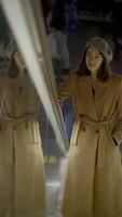 Chic Reflection Captured in Urban Setting Surrounded by Fashionable Outerwear Choices video