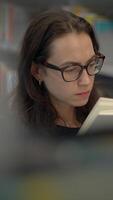A Focused Reader within a Modern Library Setting That Encourages Learning and Mindful Engagement video