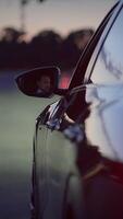 An Urban Evening Drive Featuring a Reflection Visible in the Car Mirror While Driving video