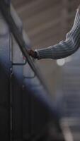 A CloseUp of a Hand Gently Resting on a Rail Within a Modern and Stylish Setting video
