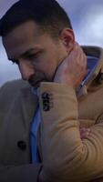 A contemplative man is outdoors wearing a stylish coat, lost in deep thought and reflection video