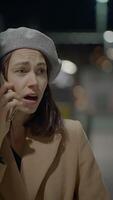 A Woman Who Appears Concerned in a Busy Urban Night Setting with Various Background Elements video