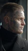A captivating portrait of a man adorned with intricate tattoos showcasing a contemplative expression video