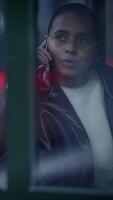 A person holding a phone stands in an urban environment while reflections surround them video