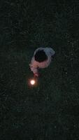 An Aerial View Capturing a Person Surrounded by Fire Flames on Grass During Dusk Hours video