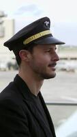 A Confident Pilot in Uniform Posing at the Airport Ready for an Exciting Journey Ahead video