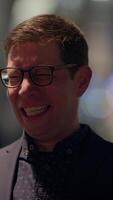 A Joyful Man Smiling Brightly in an Elegant and Charming Setting During the Night Time Hours video
