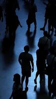 The captivating silhouettes of diverse people moving about create an intriguing scene video