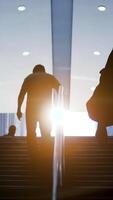 Silhouetted Figures Ascend Steps with a Backlight Glow Creating a Dramatic Effect video