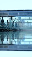 A Modern Airport Terminal showcasing Reflections and a diverse group of Passengers moving around video