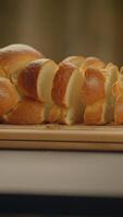 Freshly sliced bread artfully arranged on a rustic wooden board with a soft crust video