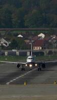 An Airplane is Landing at an Airport that has a Beautiful and Scenic Background View video