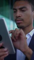 A Professional Man Using a Tablet Device in a Modern Office Environment for Work and Growth video
