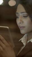 A Focused Professional Woman is Engaged Intently with a Tablet Device in Her Workspace video
