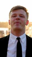 An Elegant Man Dressed in a Classy Suit is Contemplatively Looking Down While Posing video