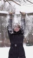 A Cheerful Woman is Smiling and Enjoying Fun Activities While Playing in the Snowy Winter video